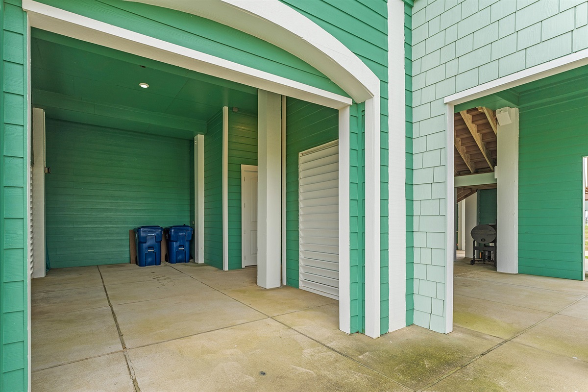 Exterior: Large covered parking and storage spaces for several vehicles.
