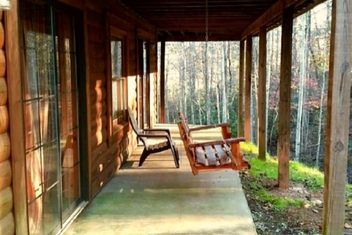 Lower level deck open to large, private back yard with stream.