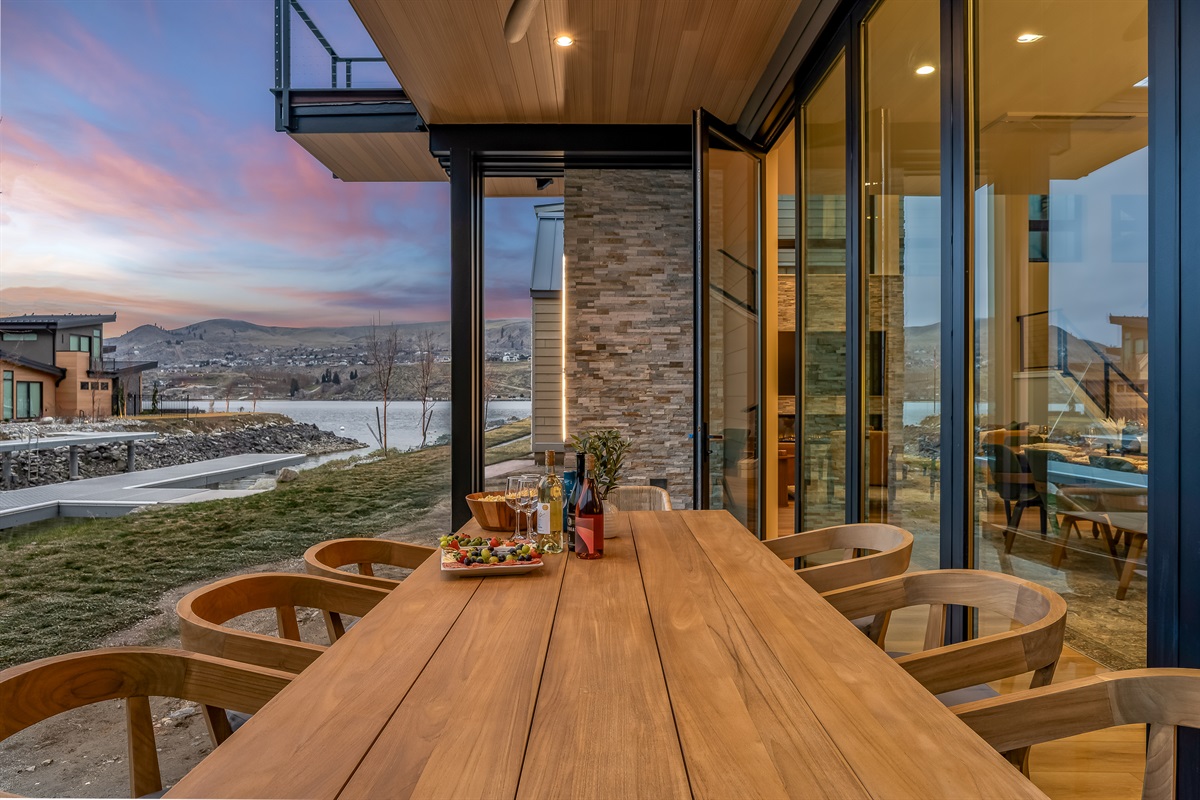 Lake views, outdoor table sliding glass wall to bring in the outdoors in, and glowing lakefront sunsets
