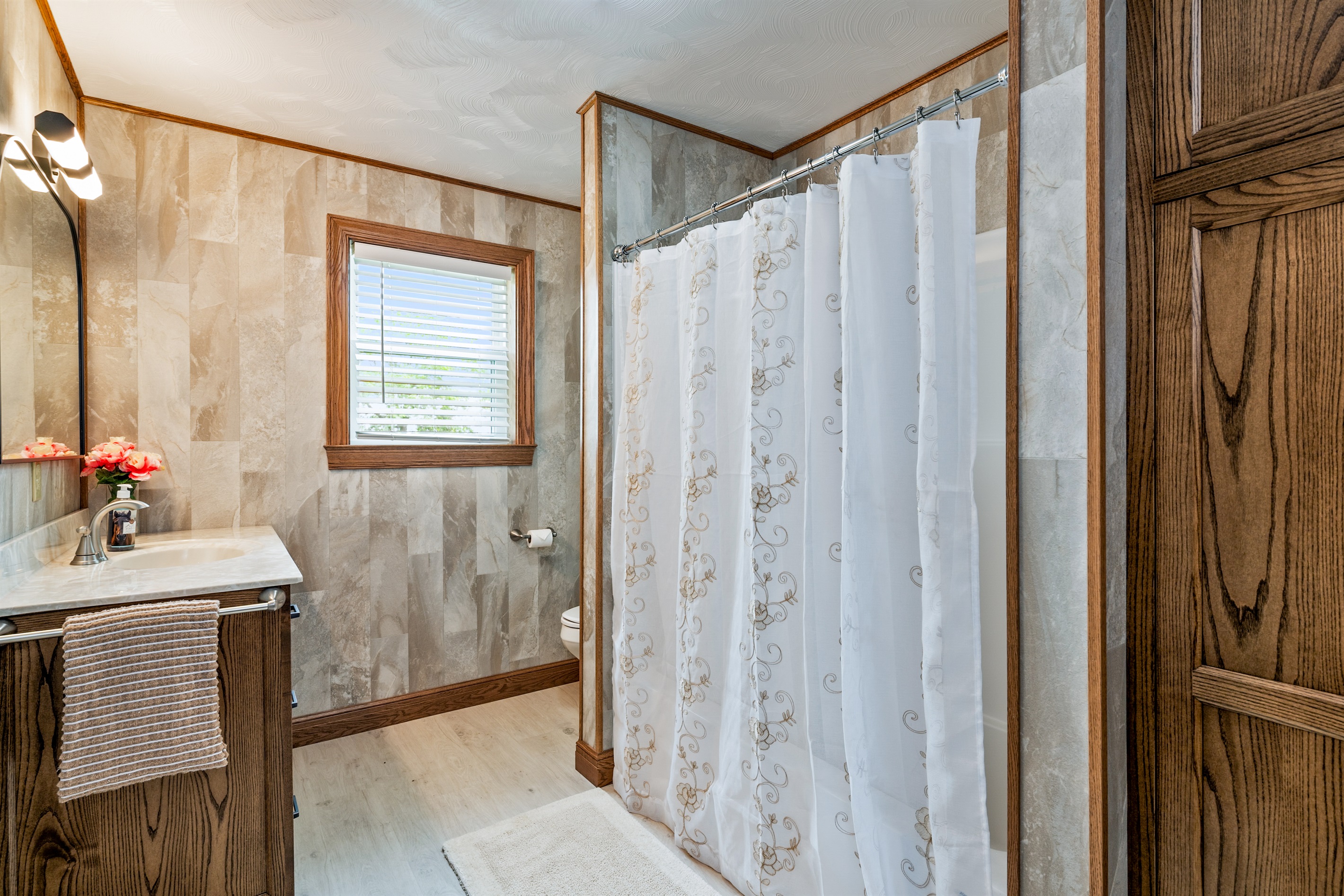 Stylish full bathroom with elegant tile work, modern fixtures, and a relaxing shower space.