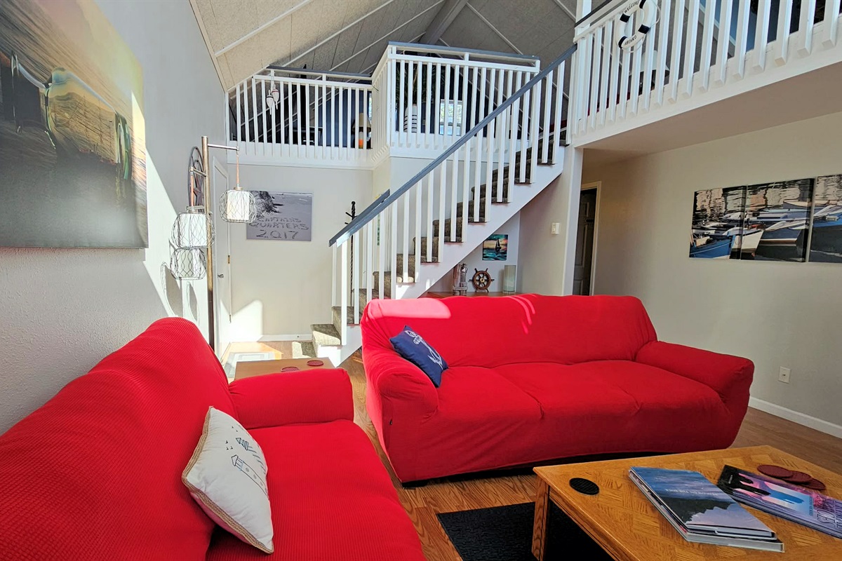 main floor living room with door to deck and garage