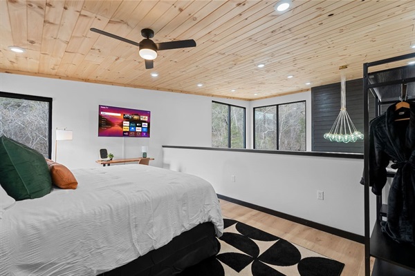 Lofted Bedroom Retreat: Relax in style with panoramic views and modern decor, perfect for unwinding!