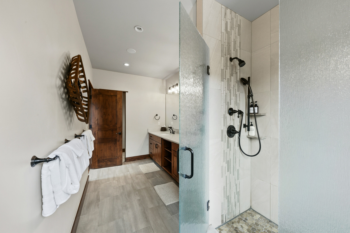 Primary bathroom with large walk-in shower and heated floors. 