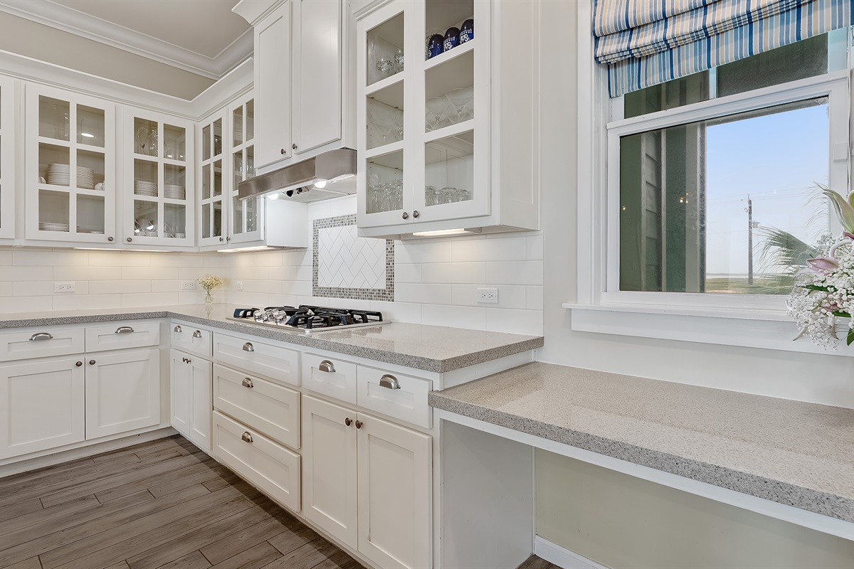 Kitchen: White cabinetry and granite counter tops throughout.
