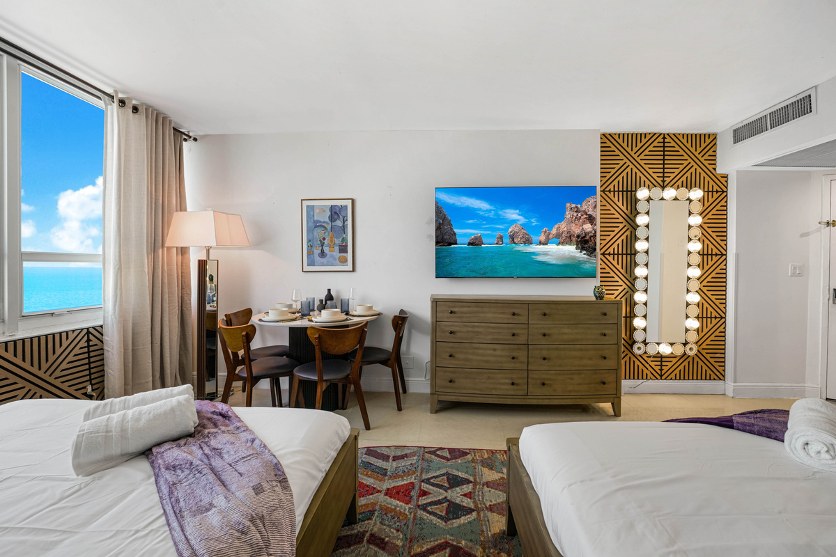 From the beds, the studio opens up to the dining nook, Smart TV and ocean-facing window in one bright, open space.