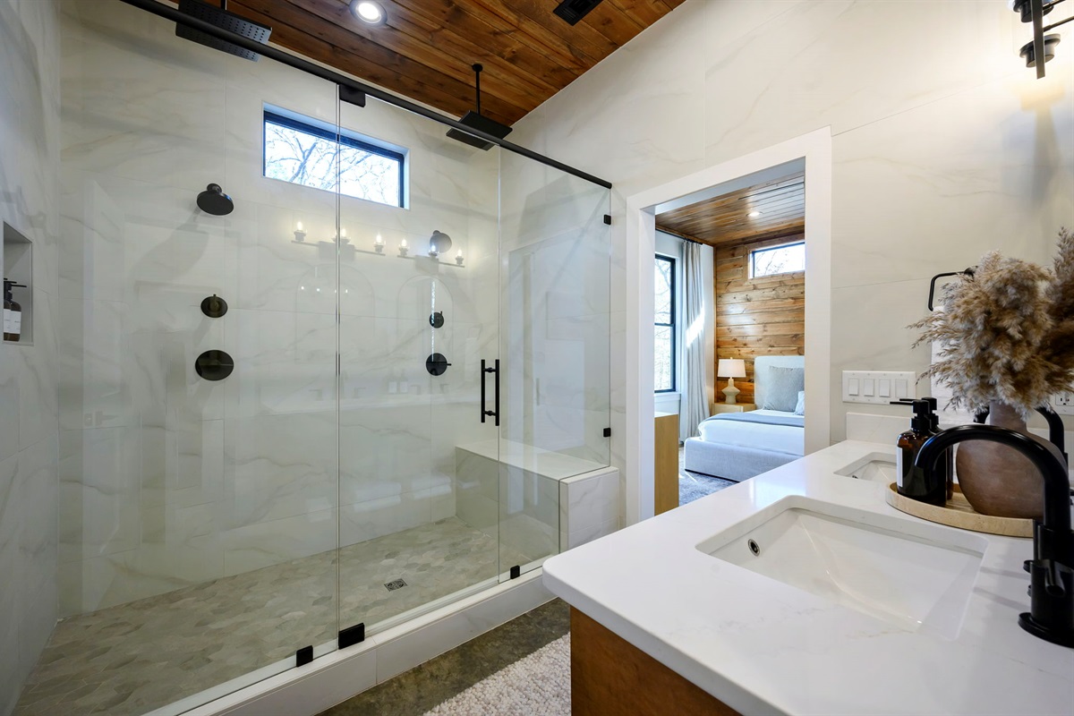 Ensuite Bathroom 3 - Attached to King Suite 3. Featuring enormous rain shower with quad showerheads, and spa-quality marble finishes. Includes premium toiletries (body wash, shampoo, conditioner, hand soap) and hotel quality towels. 
