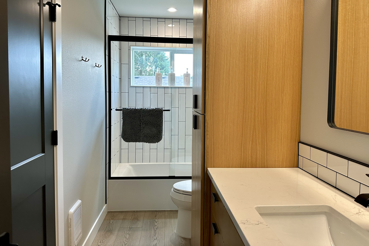 Get ready fast in crisp subway tile with a window right in the shower — with six full baths, mornings never back up here.