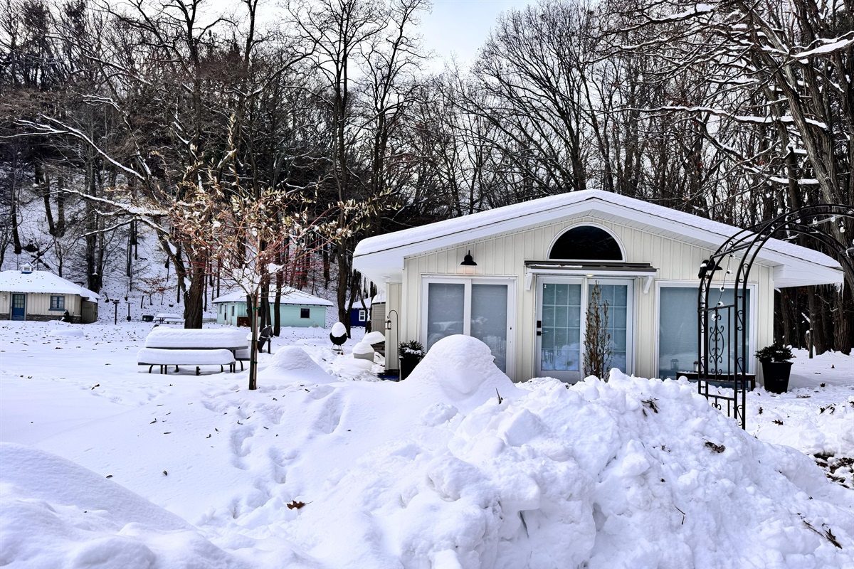 Step into your winter escape through this serene, snow dusted front entrance