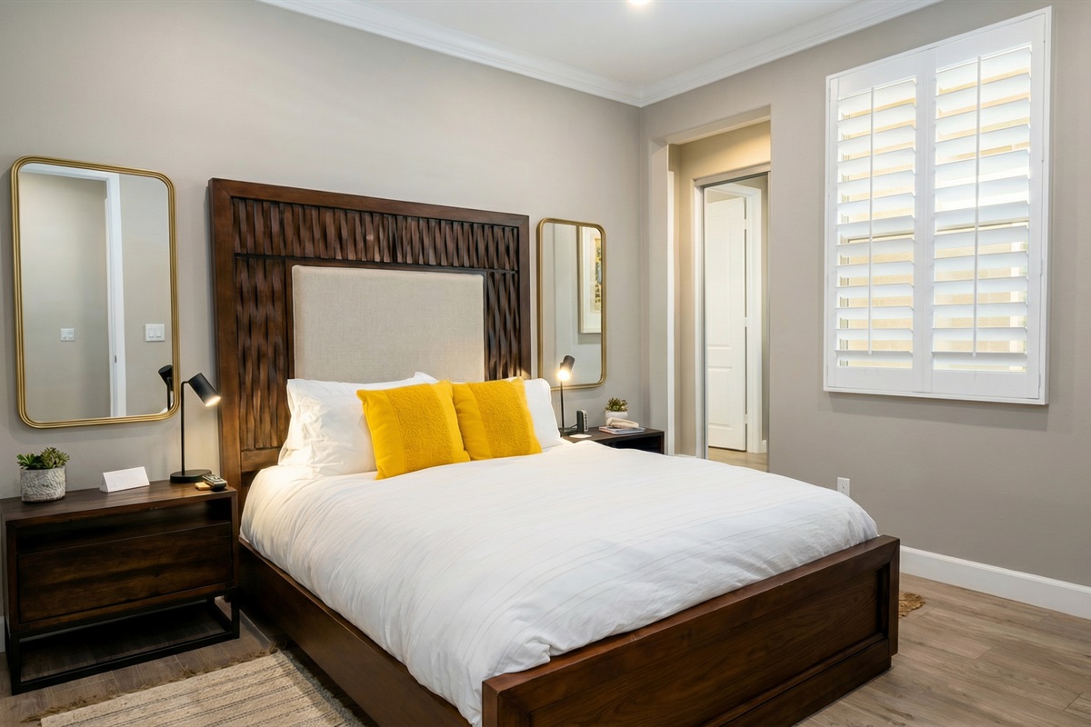 First-floor primary suite features a queen bed, smart TV, ceiling fan, closet and an ensuite bathroom with walk-in shower. (Sleeps 2)