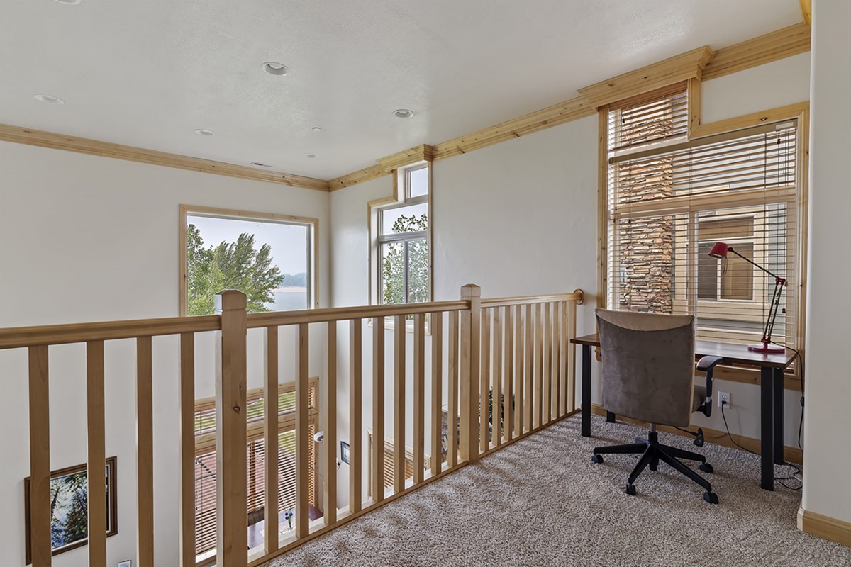 Cozy loft workspace bathed in natural light—perfect for remote work with inspiring mountain surroundings.