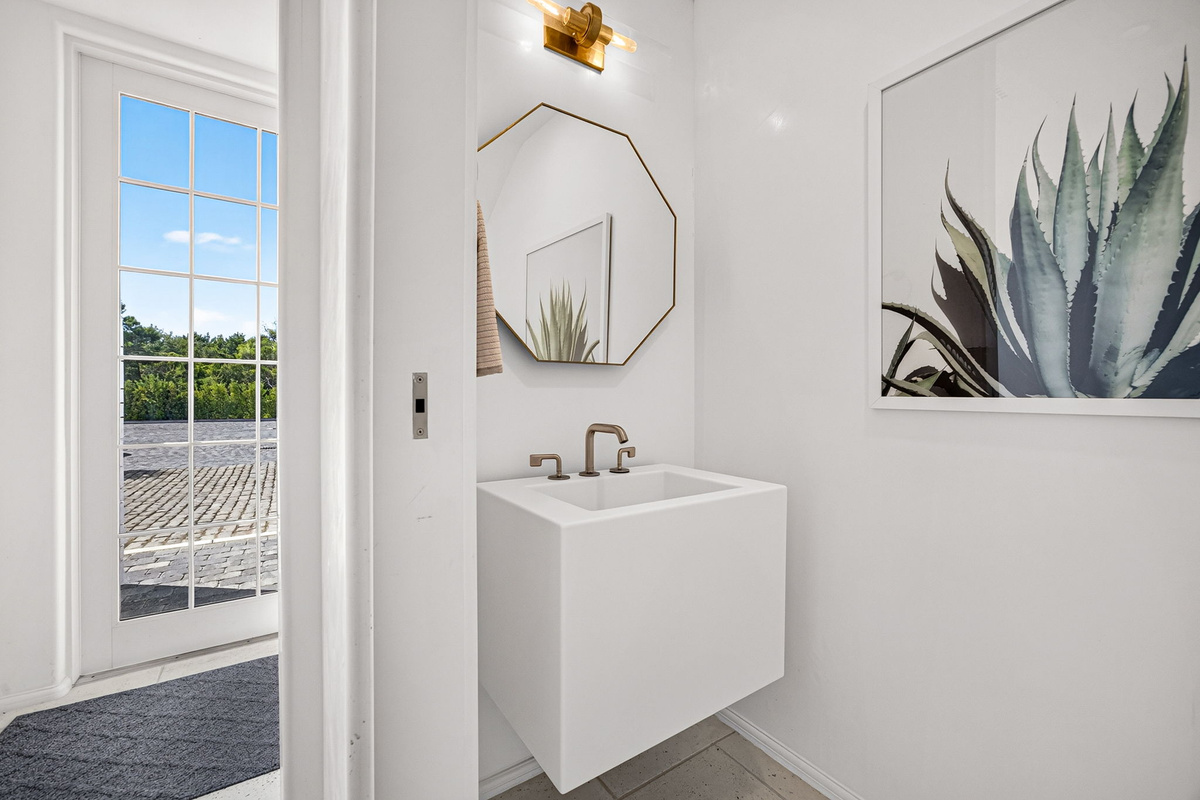 The first floor powder bath is perfectly located for easy access from the rear of the home and the kitchen and living areas.