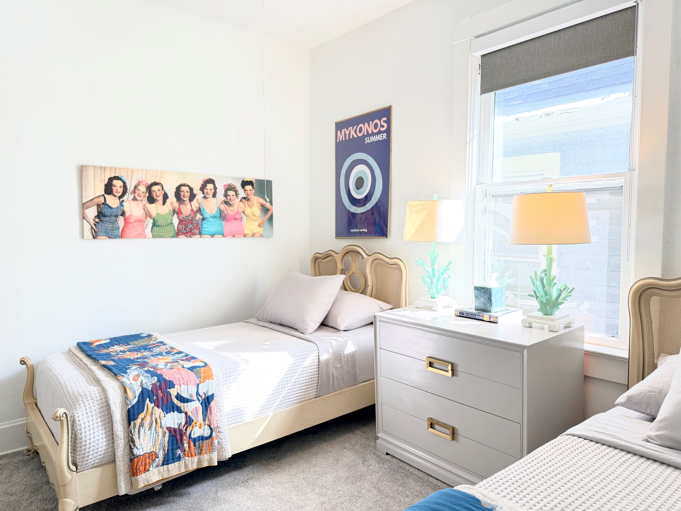 Two thoughtfully styled twin beds with supportive mattresses, crisp cotton linens, blackout shades, ceiling fan, and warm bedside lighting — a cozy, restful retreat for kids, friends, or shared stays.