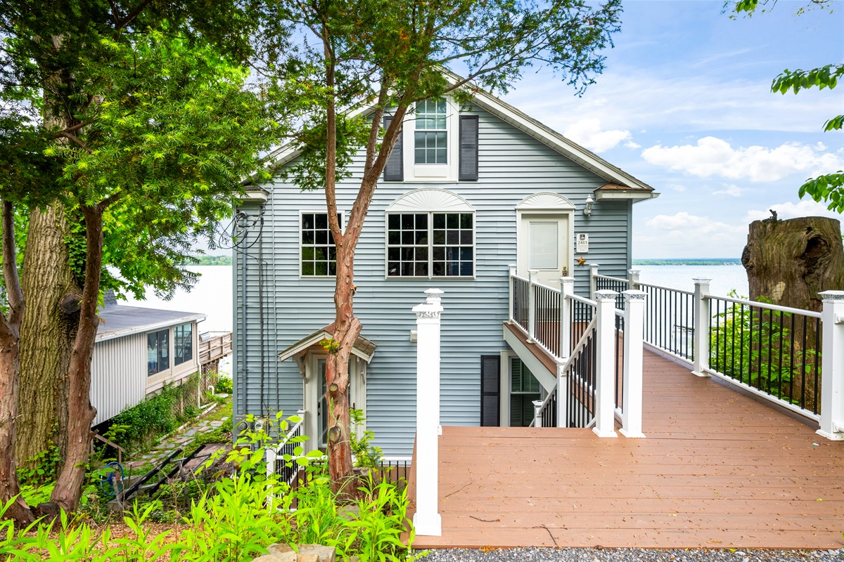 Enjoy direct lakefront living with this charming multi-level getaway, nestled among the trees with panoramic water views! 🌳🏠🌊