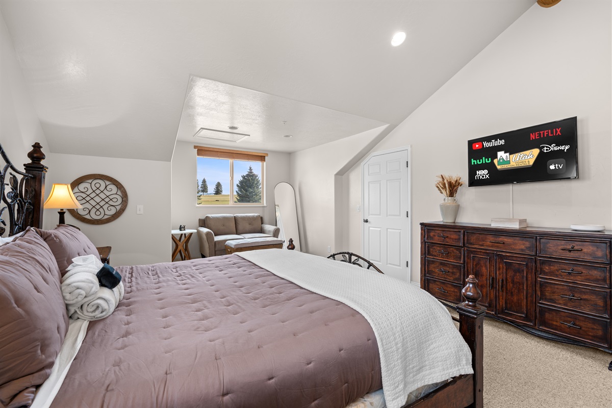 Bedroom view featuring dresser and TV for winding down at night.