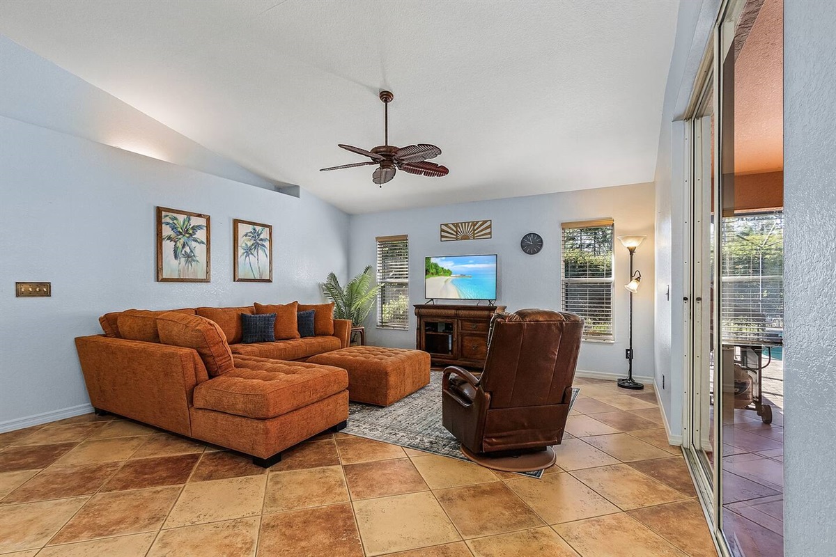 Seamless entertainment unfolds in this sleek TV-equipped living space!