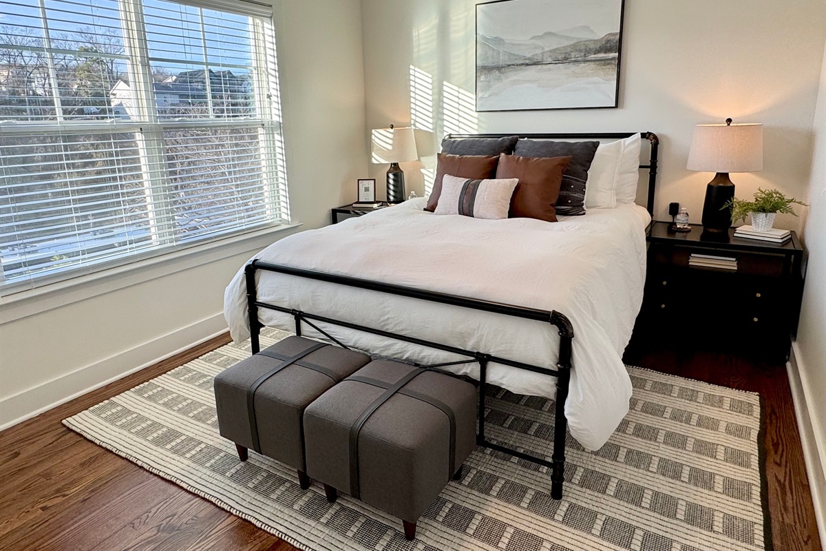 Queen bedroom #2. There is a TV with Roku mounted in front of the bed.