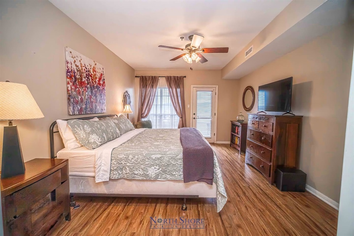 HDTV and Patio Access in Primary Bedroom