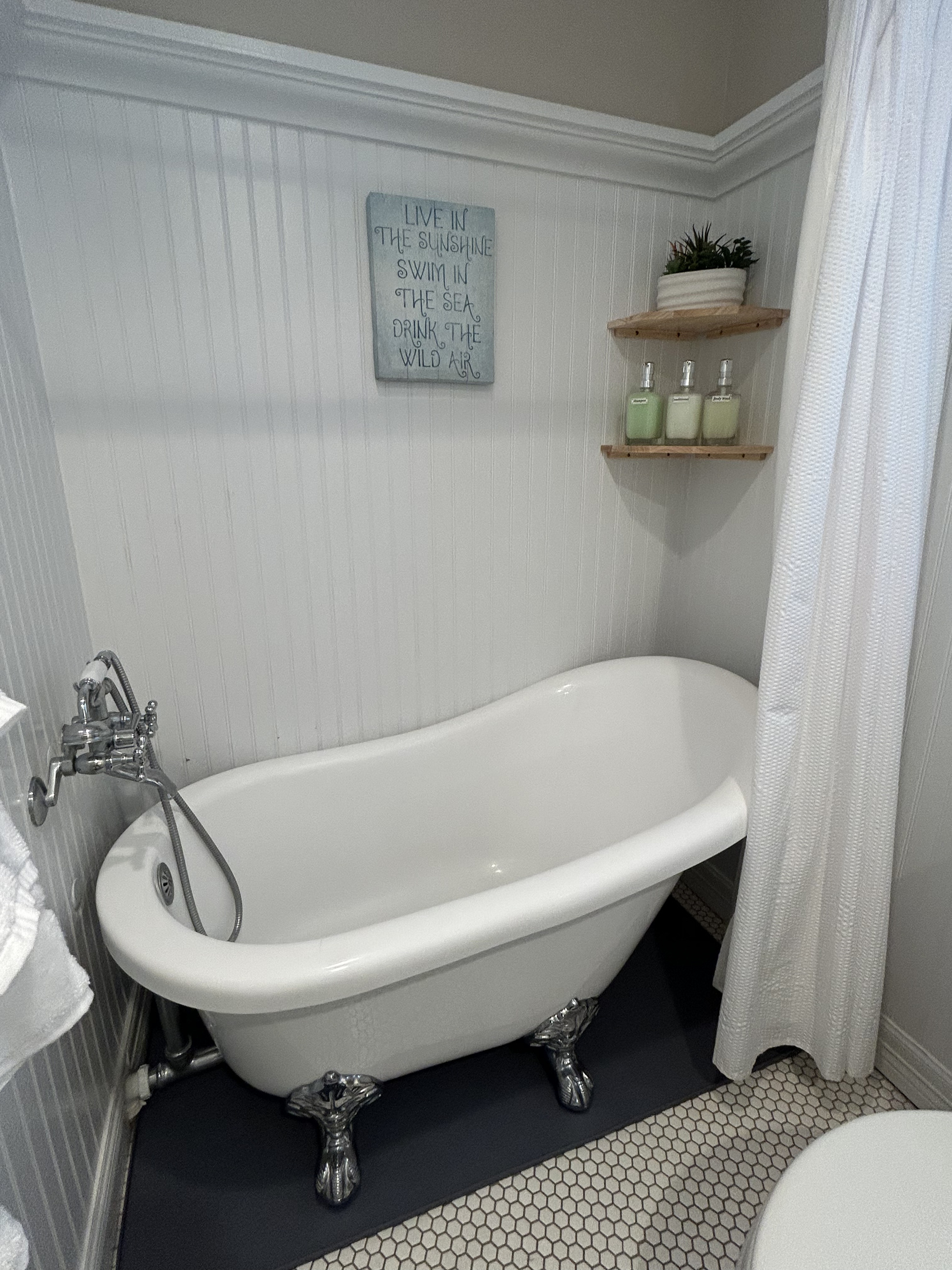 King Suite Ensuite Bathroom (Ground Level) features a charming clawfoot soaking tub and tranquil spa-like ambiance, creating the perfect retreat to relax and unwind after a day of island adventures.