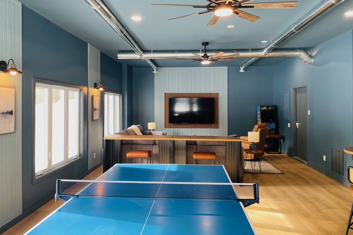 800 sq. ft. game/movie room with 2 arcades, ping pong table, Pop-a-Shot basketball and 75" TV with comfy sectional sofa and recliner.
