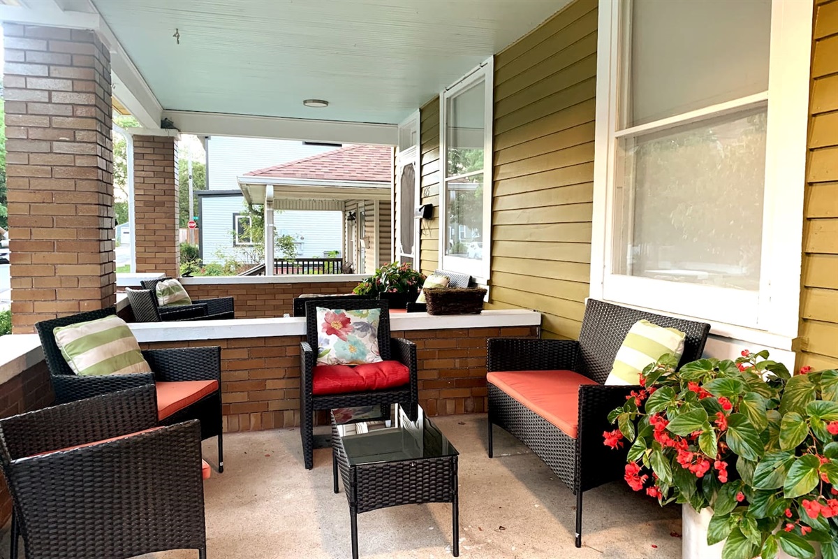 Thoughtfully furnished, covered front porch — an easy place to slow down, greet neighbors, and enjoy morning coffee or evening conversation.