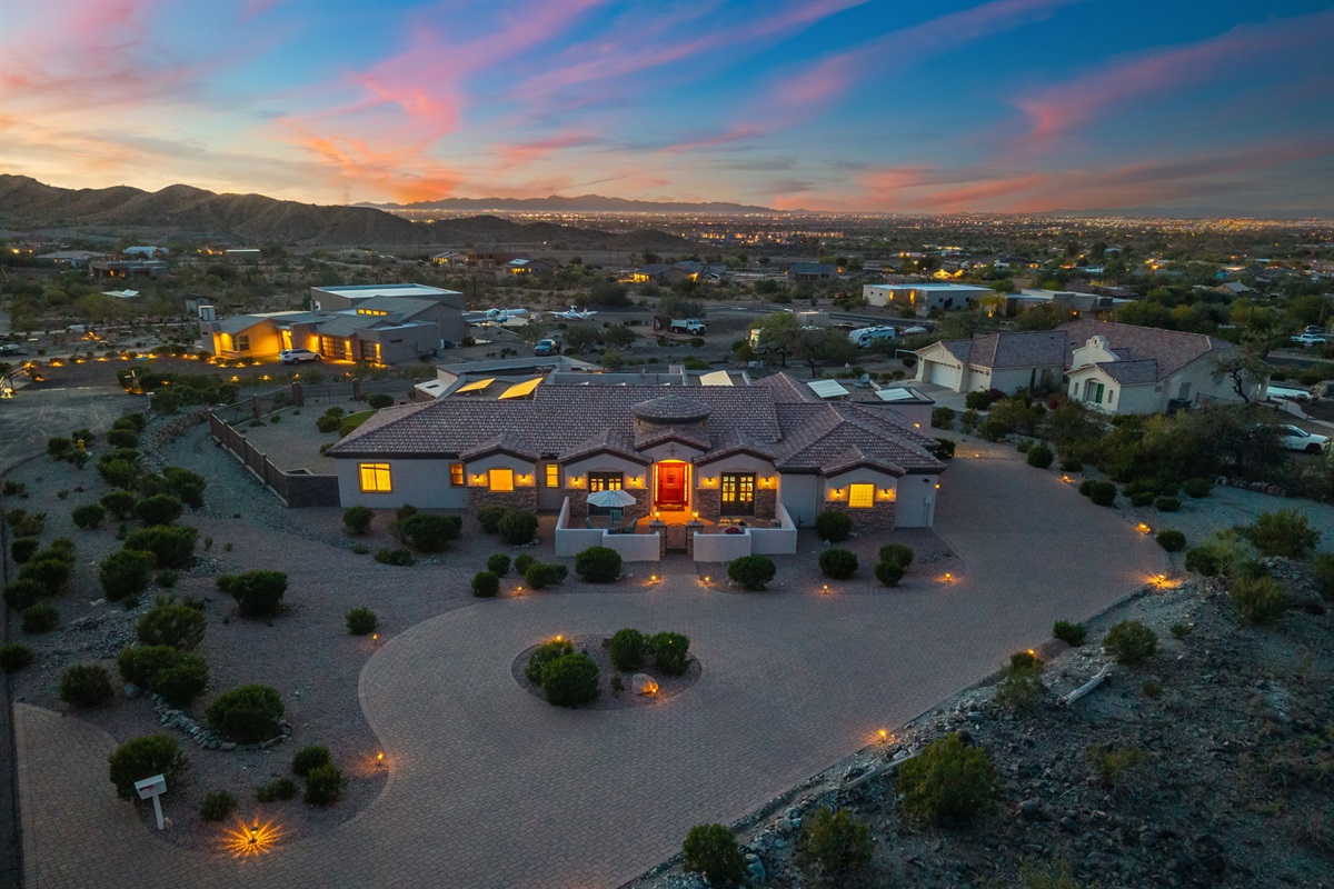 As the sun sets, the entire property transforms into a glowing desert escape.