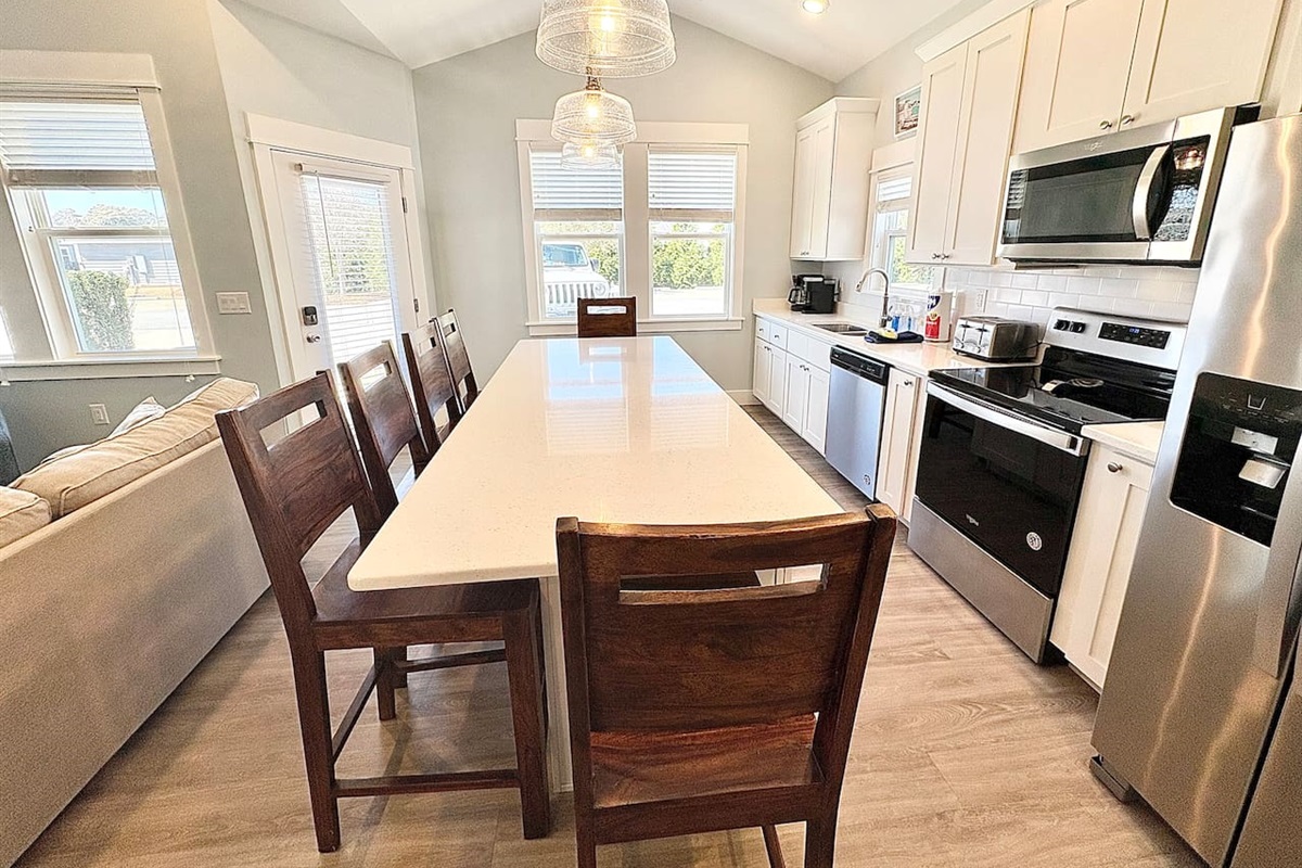 Dining area and kitchen island with seating for guests