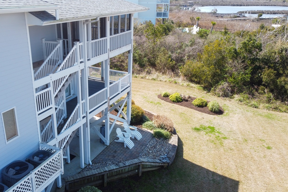 Outdoor seating area and backyard space near the marsh
