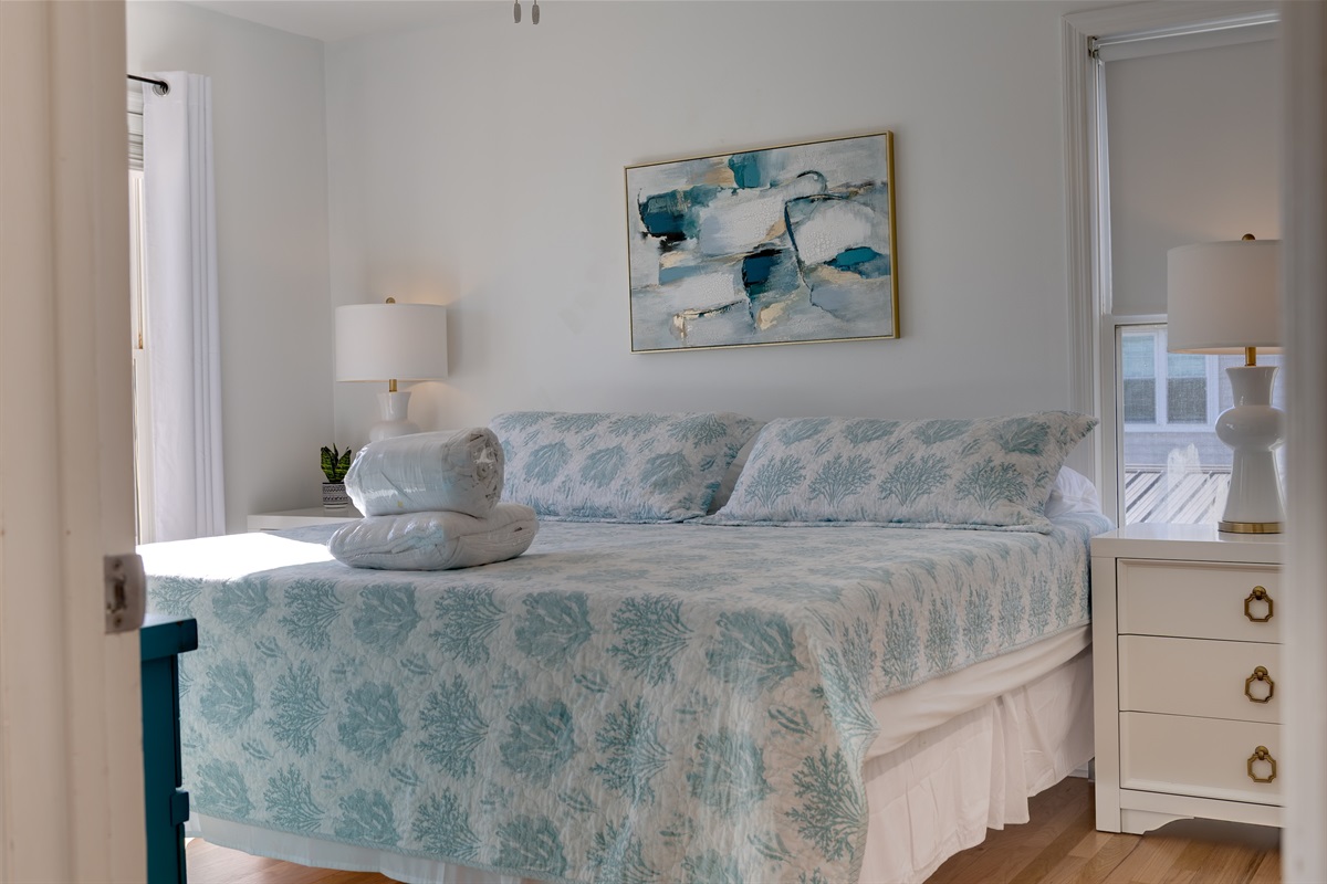 Another view of the upstairs master bedroom, thoughtfully styled for a restful night&rsquo;s sleep after a day by the shore