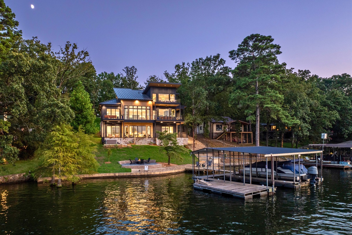 A gorgeous home with expansive outdoor spaces, designed for maximizing the enjoyment of the lake and its tranquil surroundings.