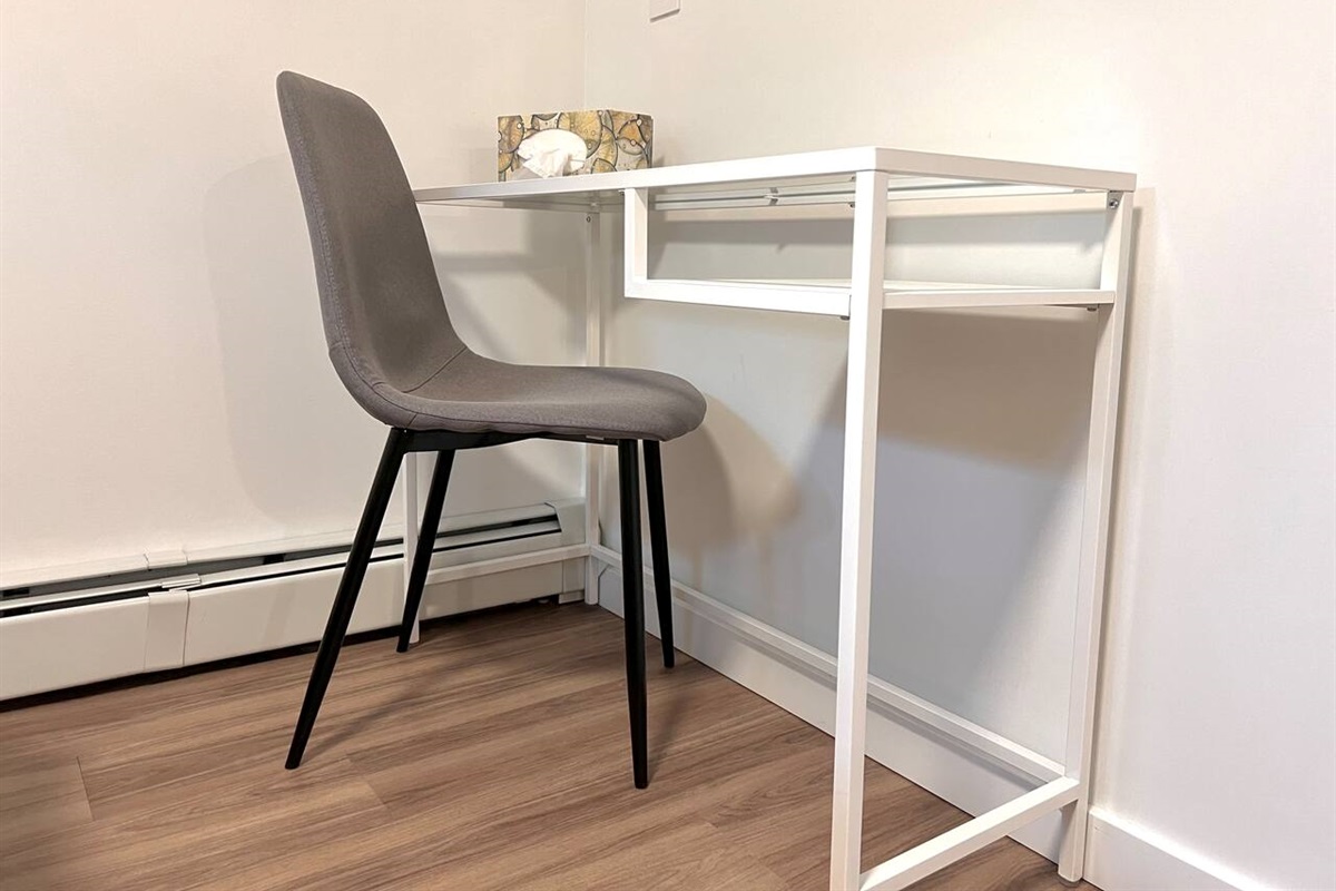 Dedicated workspace located in the bedroom with desk and chair.