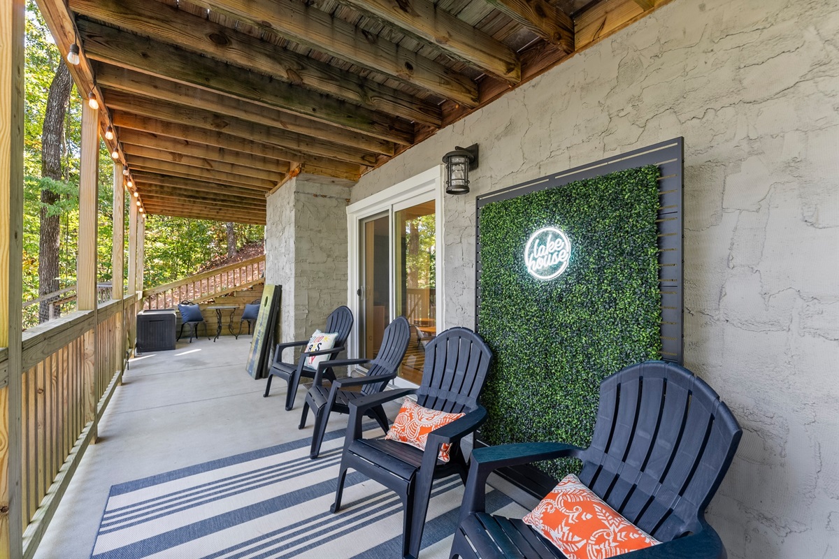 The lower deck holds lots of fun - play cornhhole or take photos in front of the neon sign!