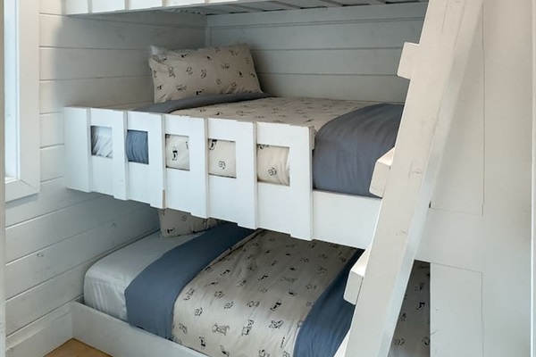 The bunk room is a dream for kids (or playful adults), with triple twin beds and space to relax, recharge, or tell ghost stories.