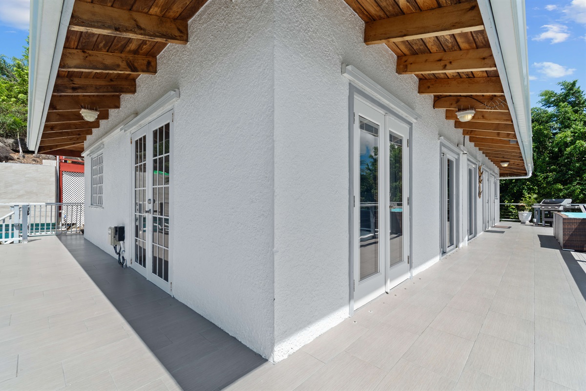 The left path leads to the pool, the right leads to the front door.