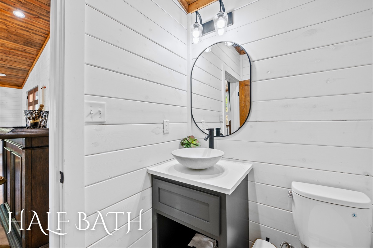 A modern and stylish half bathroom tucked away in the laundry room with clean lines and charming details.