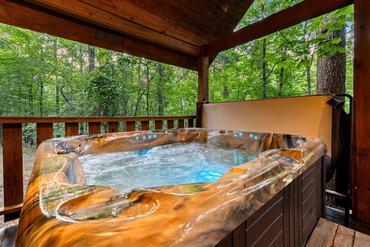 Private hot tub tucked beneath the trees—ideal for a late-night soak under the stars.