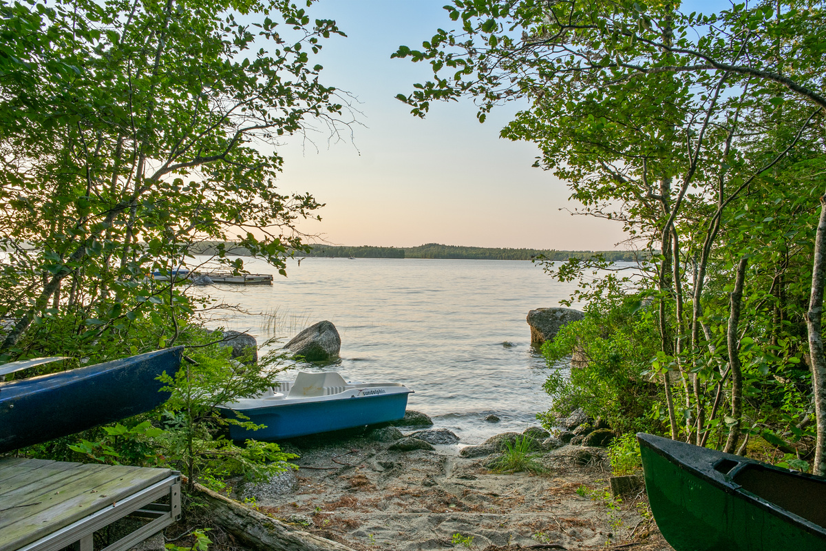 The beachy water entry at the end of the trailer path at Loonrise Point! Soft sandy shore leads into shallow Beech Hill Pond with complimentary paddle boat, canoe, and kayaks. Easy wade-in swimming and launching spot in Otis, ME.