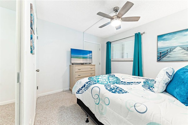 Second bedroom with queen sized bed, smart TV and closet
