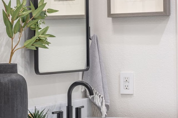 The shared hallway bathroom features marble countertops, modern fixtures, and warm wood cabinetry. Located between Bedroom 1 and Bedroom 2, this bathroom is easily accessible from Bedroom 3 and the main living spaces.