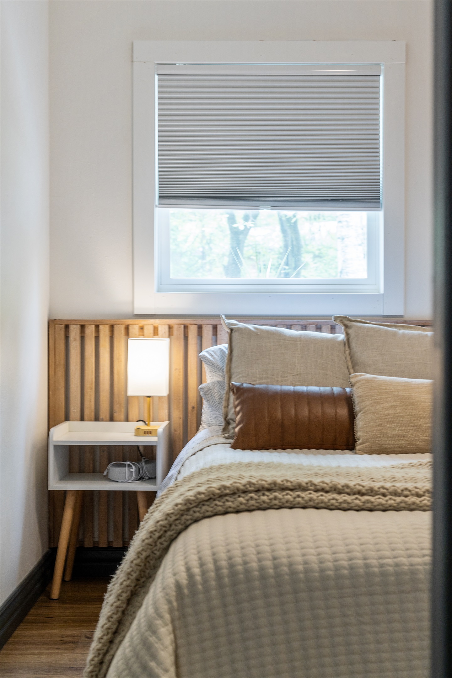 Settle into the cozy queen bed and unwind with the warm glow of bedside lamps perfect for evening reading.