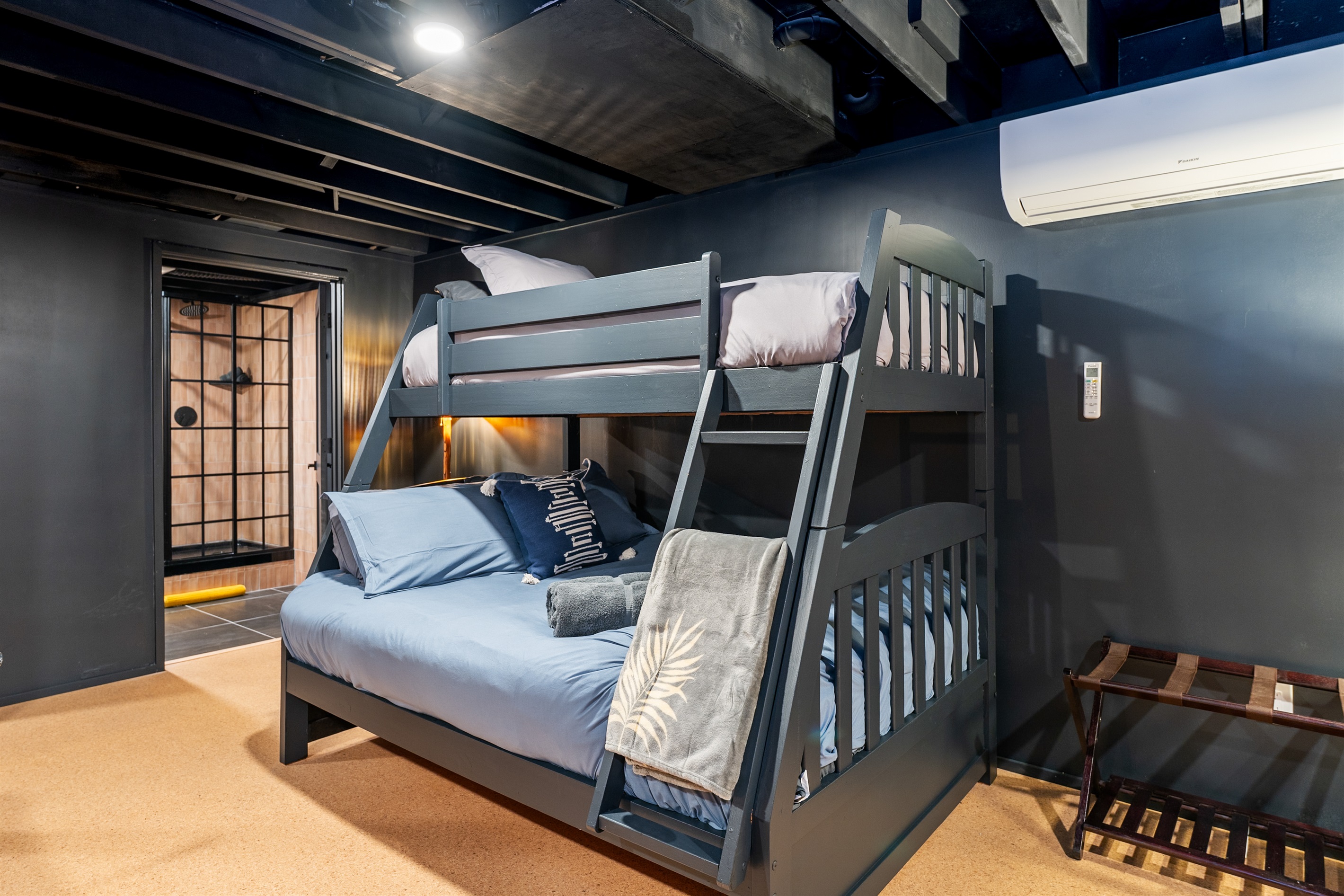 Fun bunk room ideal for kids or groups, offering comfortable beds and a playful, sleepover-ready setup.