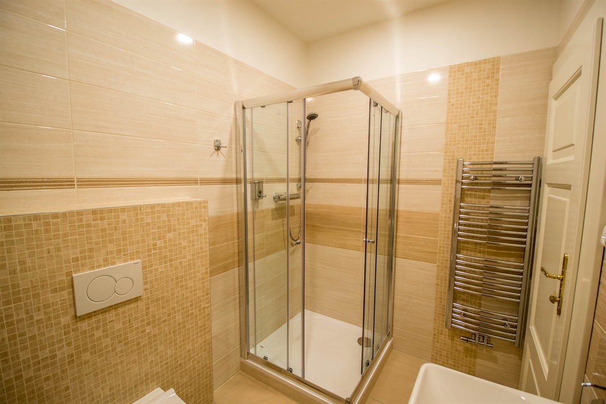 1st bathroom with a shower unit 