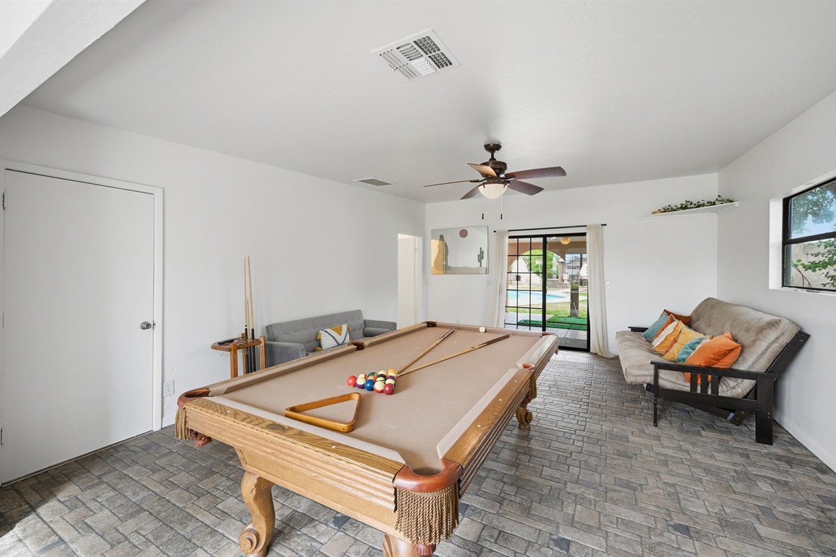 This game room features a full-size pool table, cozy lounge seating, and warm Southwestern charm for hours of laid-back entertainment.