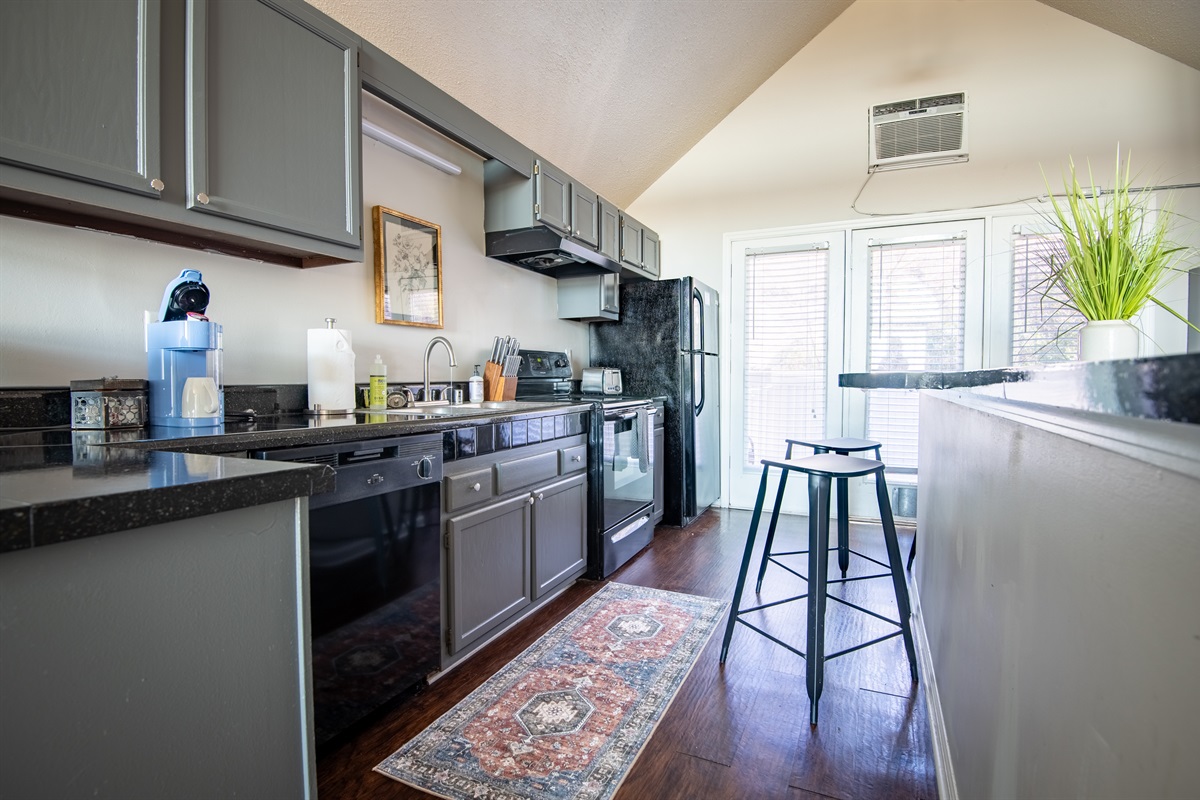 Unit G's elongated kitchen is stocked with everything you might need to whip up your favorite meal, and also has a long bar area with extra counter space and bar seating for your convenience!