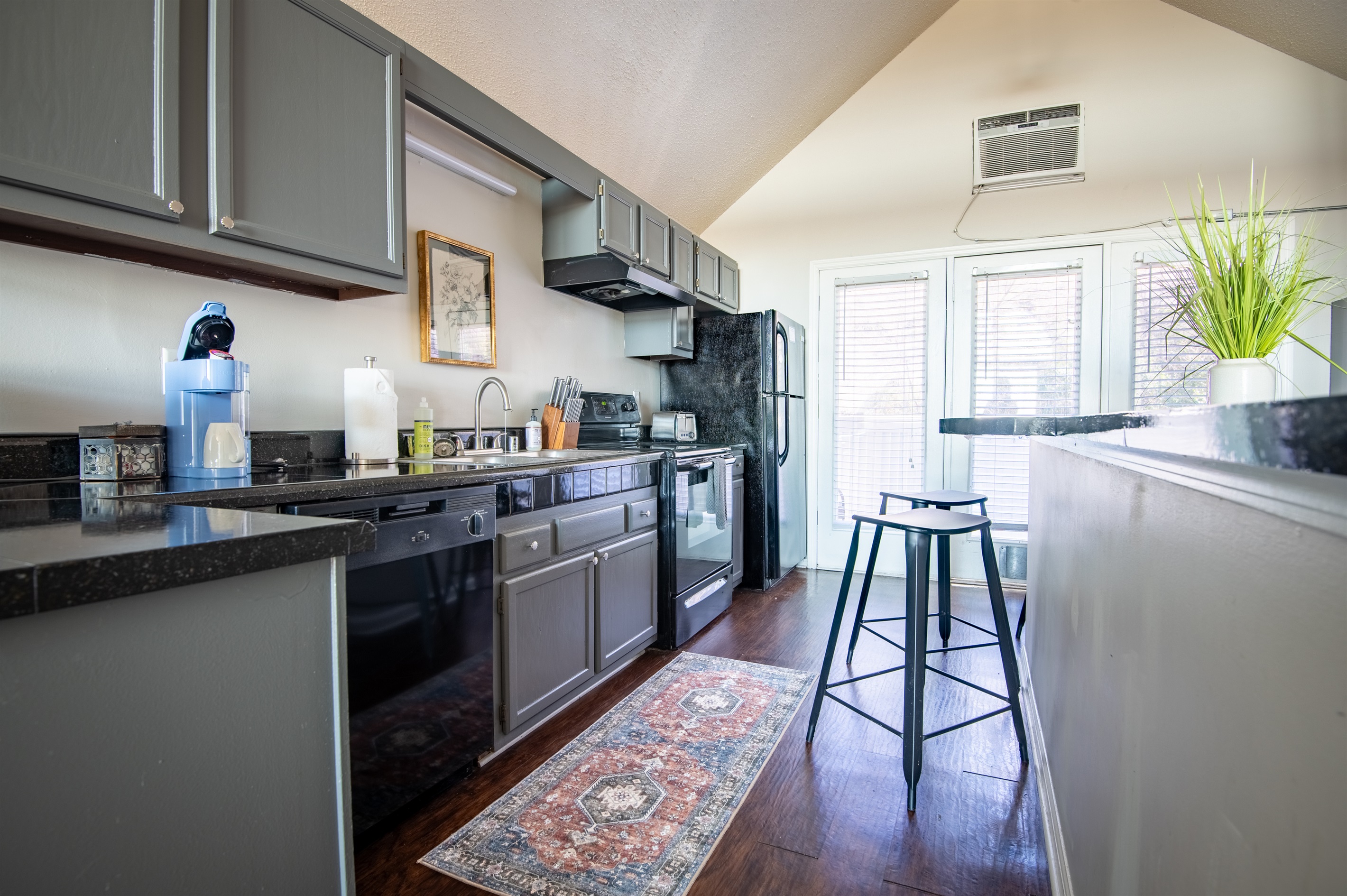Unit G's elongated kitchen is stocked with everything you might need to whip up your favorite meal, and also has a long bar area with extra counter space and bar seating for your convenience!