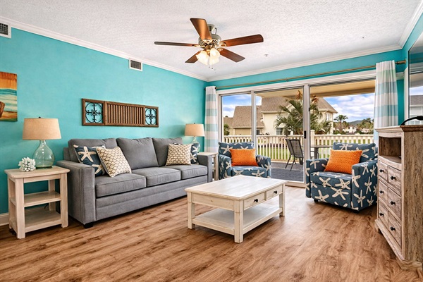 🛋️ Spacious living room featuring a sleeper sofa, smart TV, and dining area, with the added bonus of a ground floor patio for easy access. 🌳