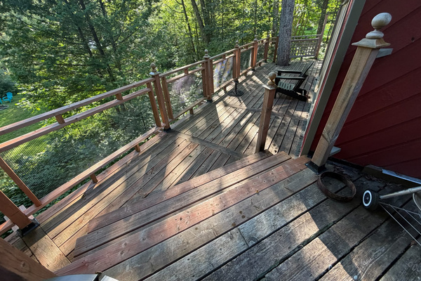 Cottage wrap-around deck with fire pit in distance