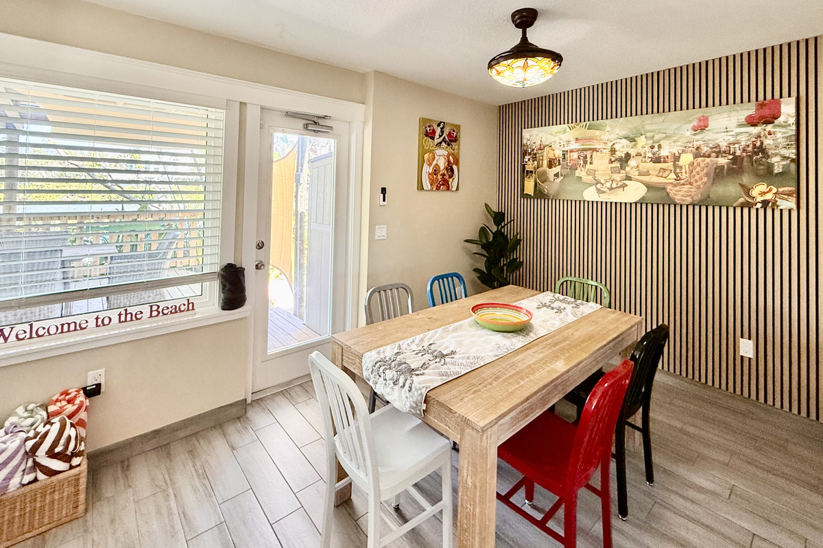 Dining Room of Manatee Suite at AMI Beach Lagoon with View to the Pergola and Vista Lake