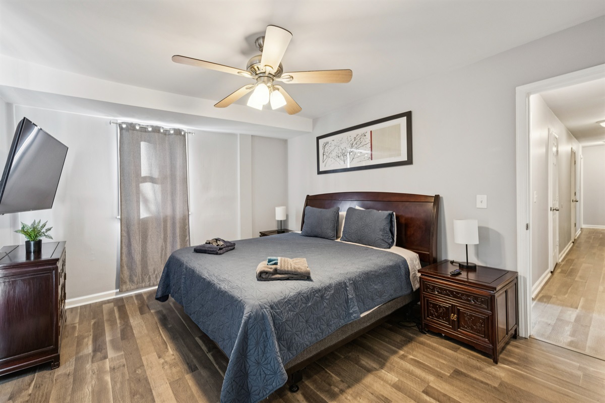 Bedroom 1: Large king bedroom with a ceiling fan and Roku TV