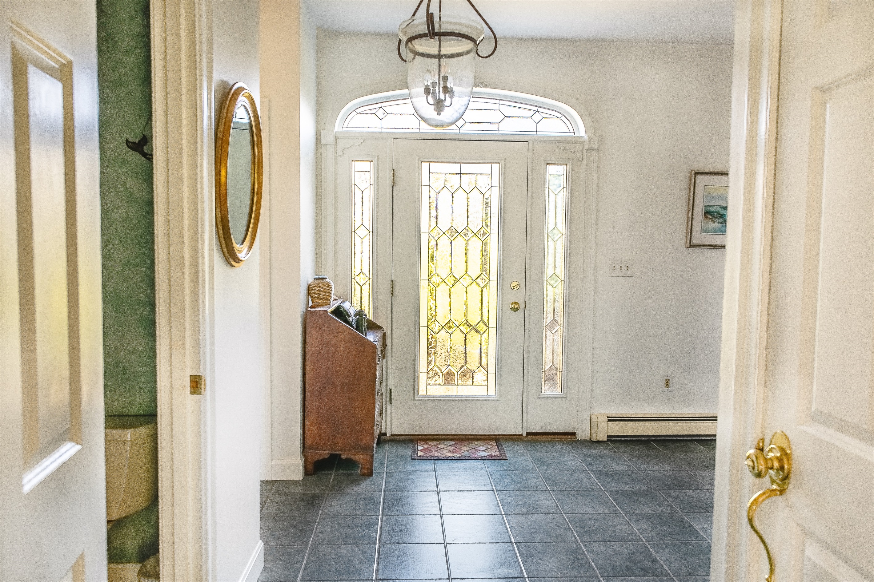 Enter through the grand front door into a bright formal foyer. This central entry point connects the main living areas and features a convenient half-bath just off the hallway, making it easy for your group to settle in upon arrival in Acadia.