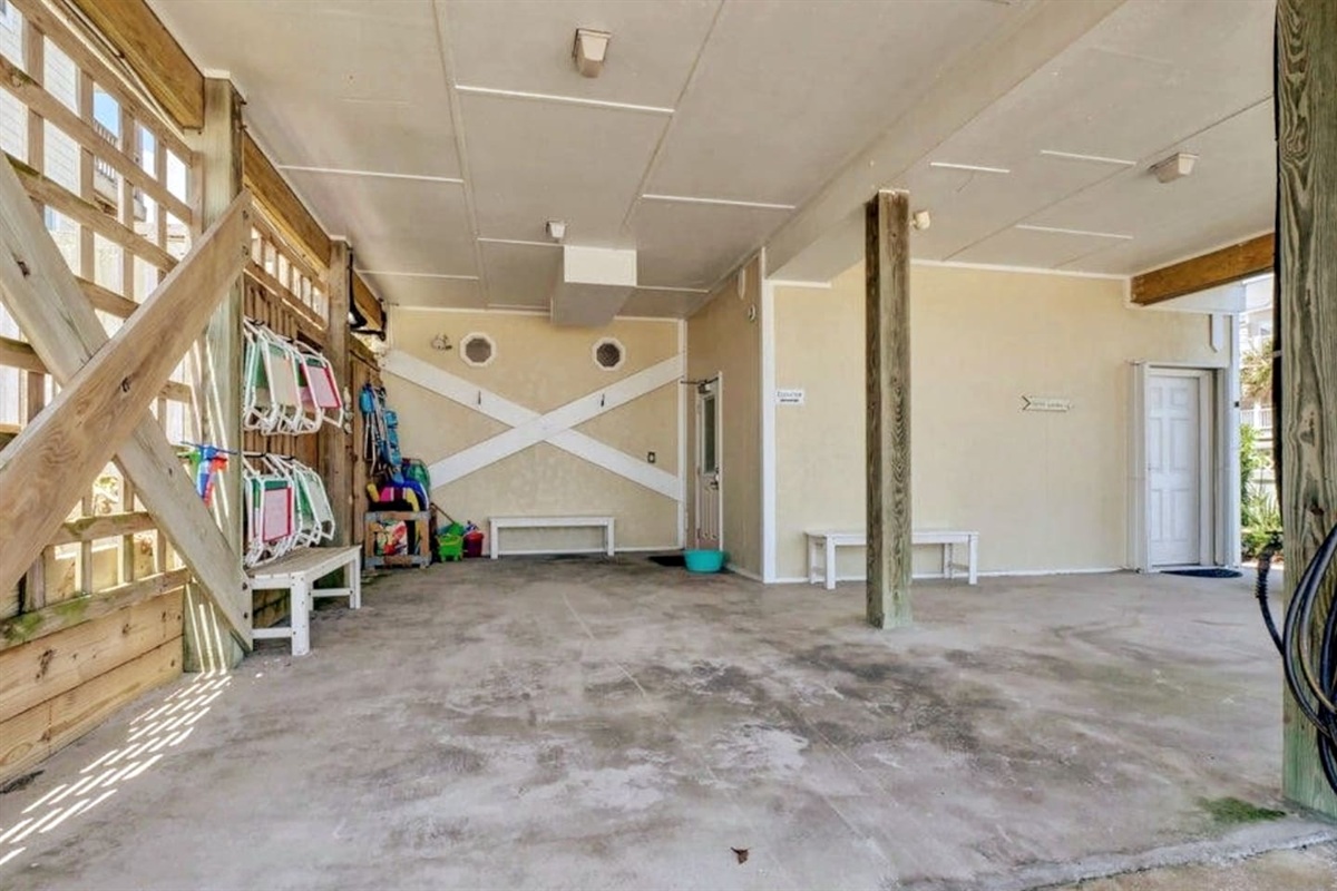Carport. Beach chairs, toys, boogie boards, and Shibumi Shade provided for your convenience. Elevator access is the door on the right side of this picture. Outdoor showers located on left side of this picture (makes it easy to get all the sand off!).